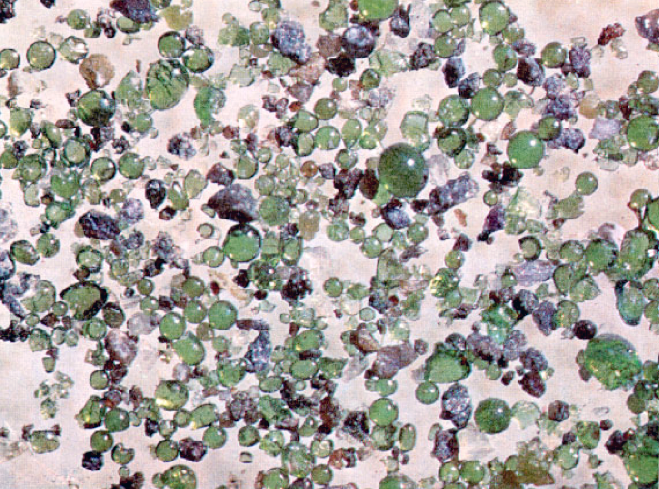 Green glass beads 40-250 microns across (Carusi et al. 1972)