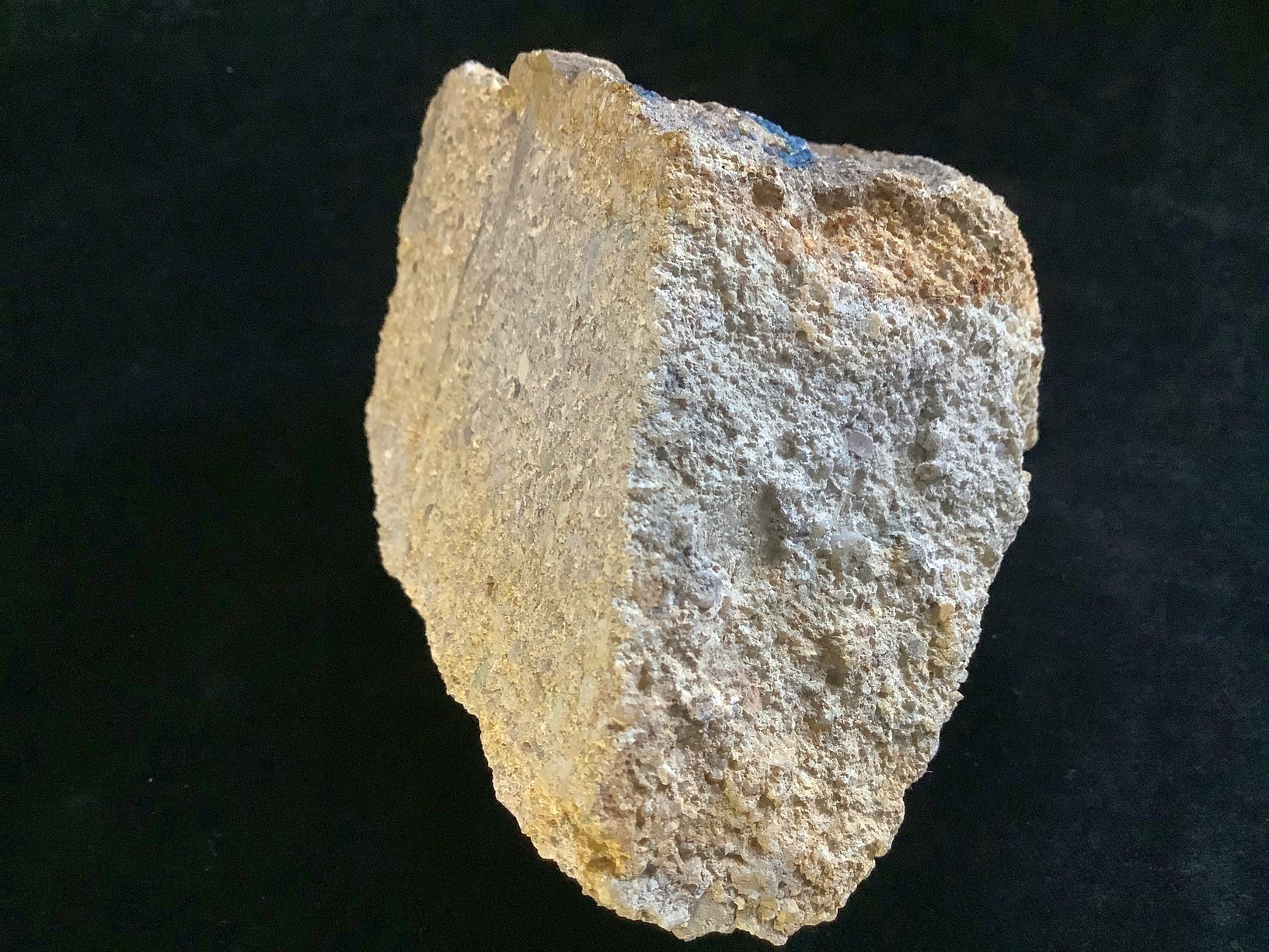 Hand specimen of sandstone on black background