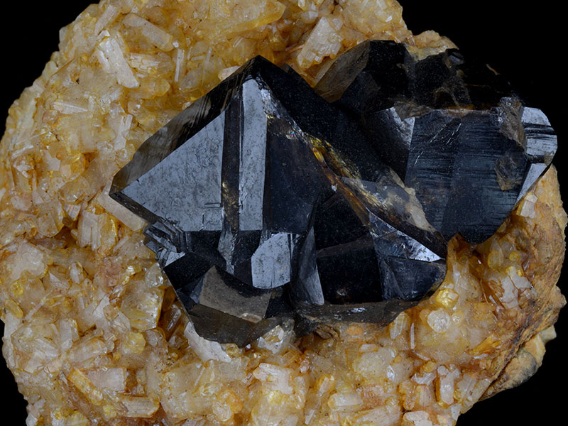 Cassiterite on topaz, specimen 4 cm across